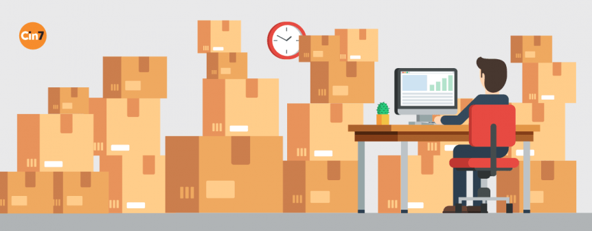 Someone performs inventory management in an office packed full of boxes.